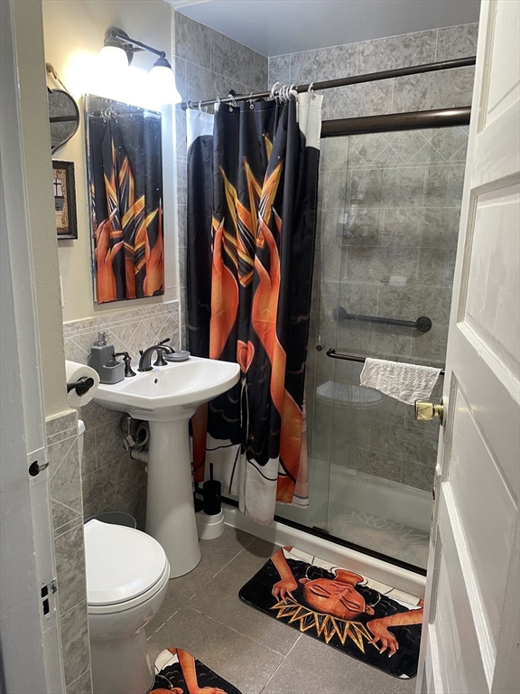 53 Mt Ida Road, Unit 1 Boston, MA 02122 - Photo 9 of 10 a bathroom with a sink toilet and shower