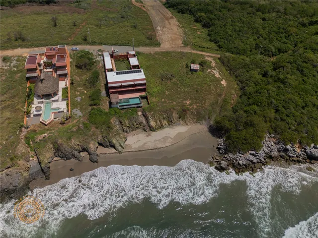 an aerial view of residential house with outdoor space and trees all around