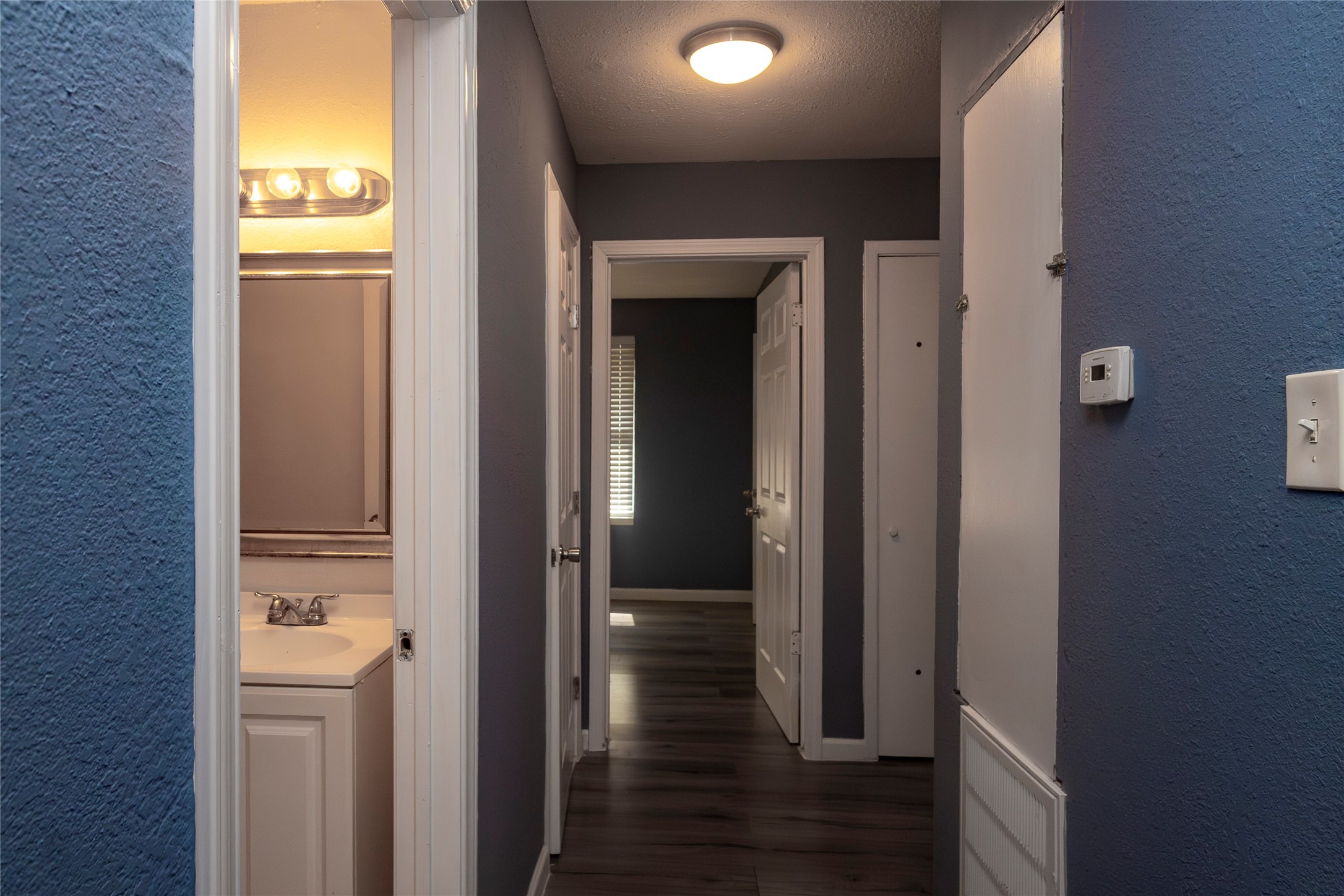 716 Hargest Street, Unit B Prairie View, TX 77445 - Photo 4 of 11 a view of a hallway with wooden floor and a bathroom