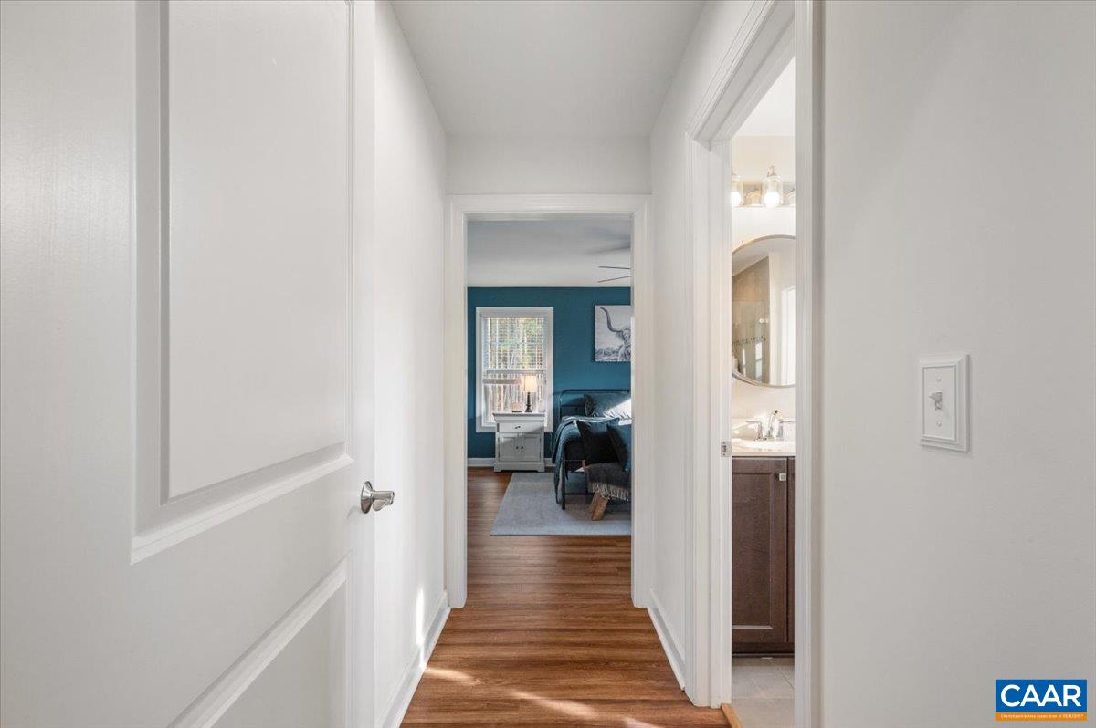 481 Country Creek Way Palmyra, VA 22963 - Photo 14 of 66 a view of a hallway with wooden floor and a bathroom