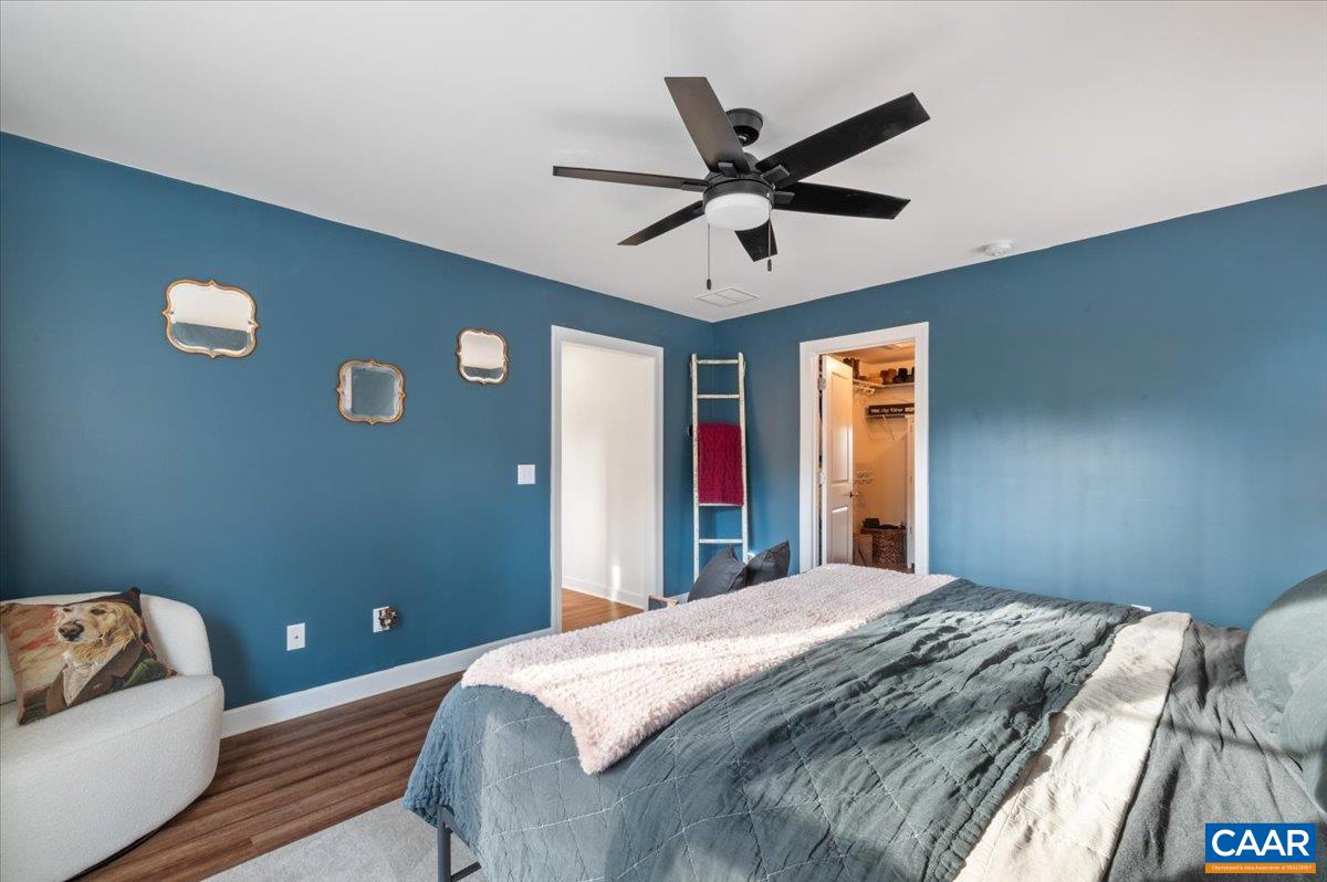 481 Country Creek Way Palmyra, VA 22963 - Photo 16 of 66 a bedroom with a bed and a chandelier