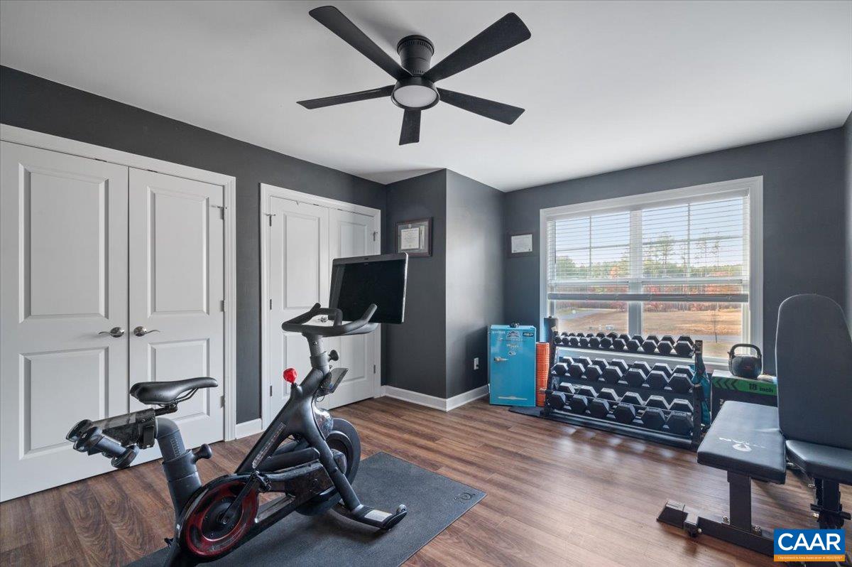 481 Country Creek Way Palmyra, VA 22963 - Photo 25 of 66 a view of workspace with wooden floor windows gym equipment and windows