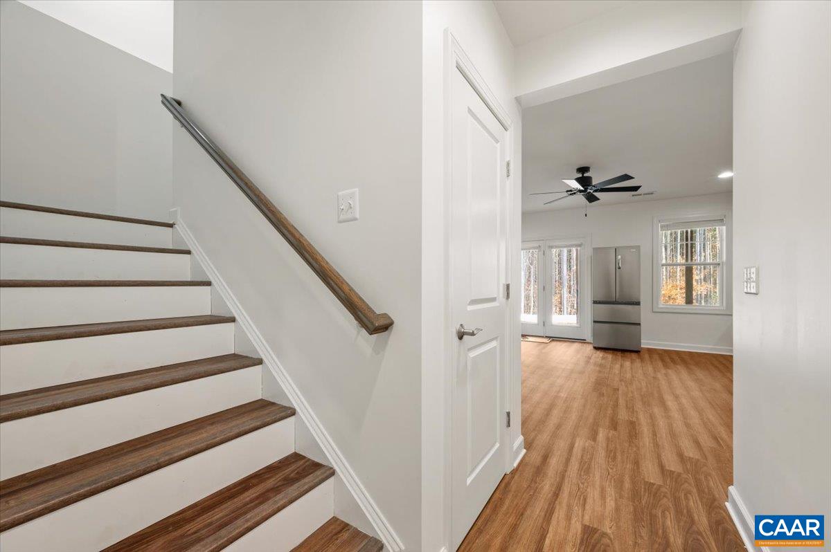 481 Country Creek Way Palmyra, VA 22963 - Photo 27 of 66 a view of a hallway with wooden floor and staircase
