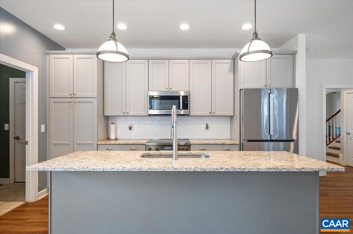 481 Country Creek Way Palmyra, VA 22963 - Photo 3 of 66 a kitchen with kitchen island granite countertop stainless steel appliances a sink stove and refrigerator