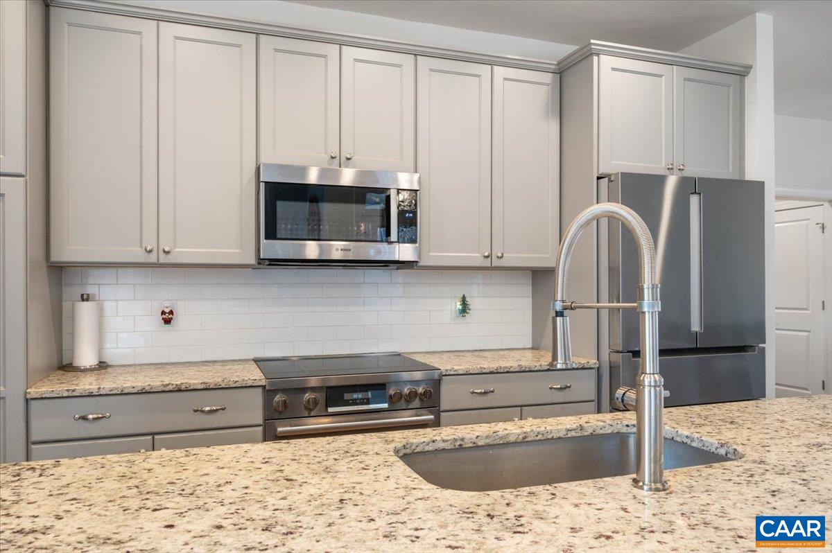 481 Country Creek Way Palmyra, VA 22963 - Photo 5 of 66 a kitchen with stainless steel appliances granite countertop a stove a sink and a microwave