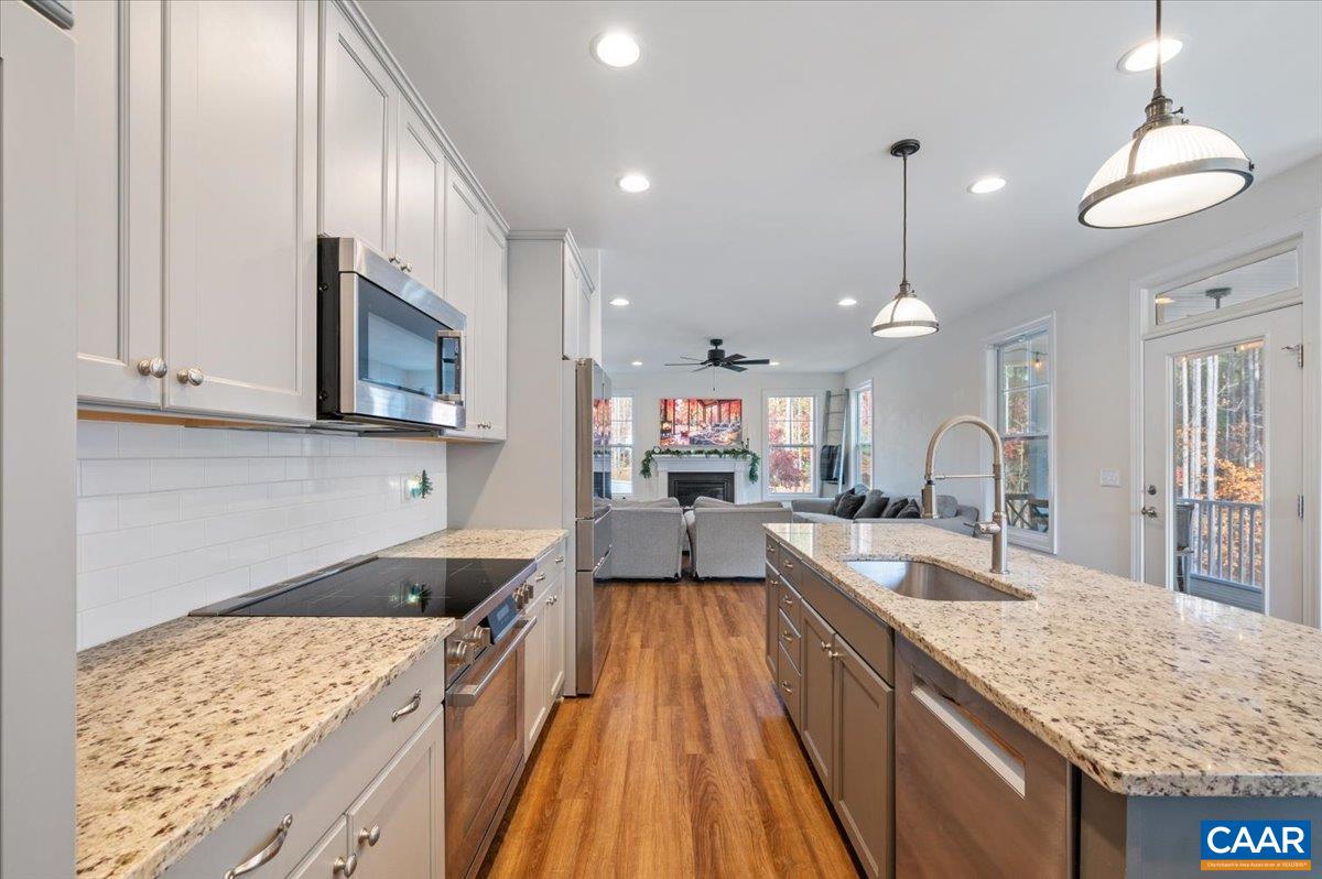 481 Country Creek Way Palmyra, VA 22963 - Photo 6 of 66 a large kitchen with granite countertop a lot of counter space