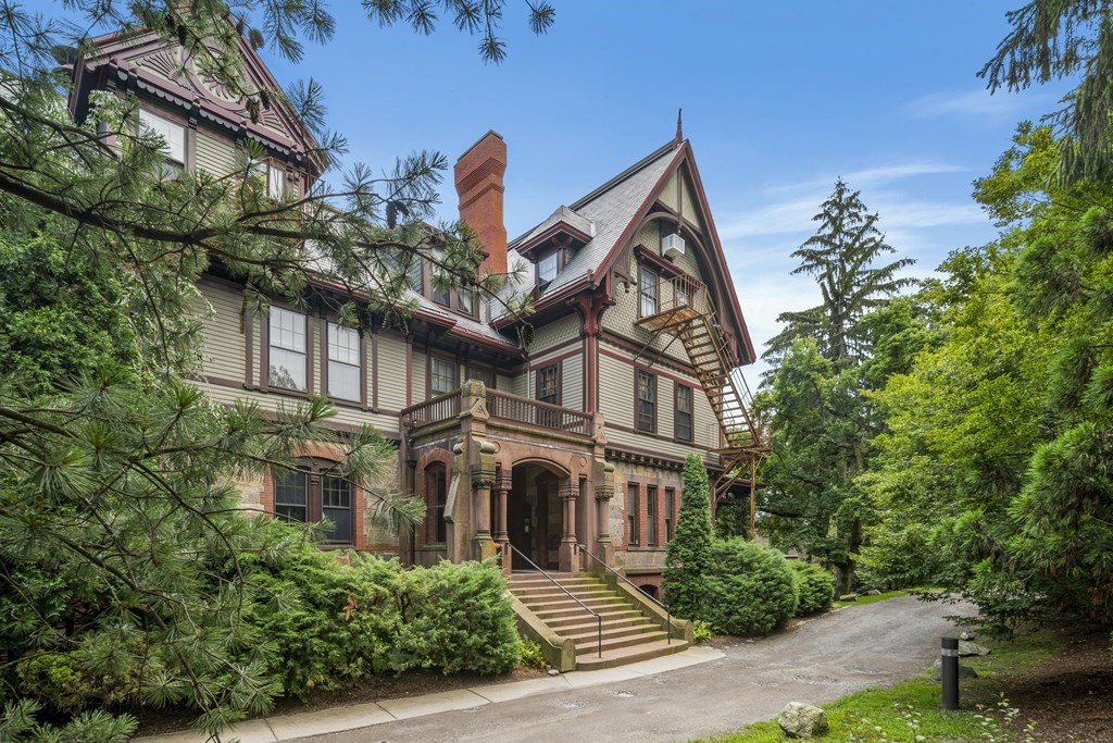 a front view of a house with a garden