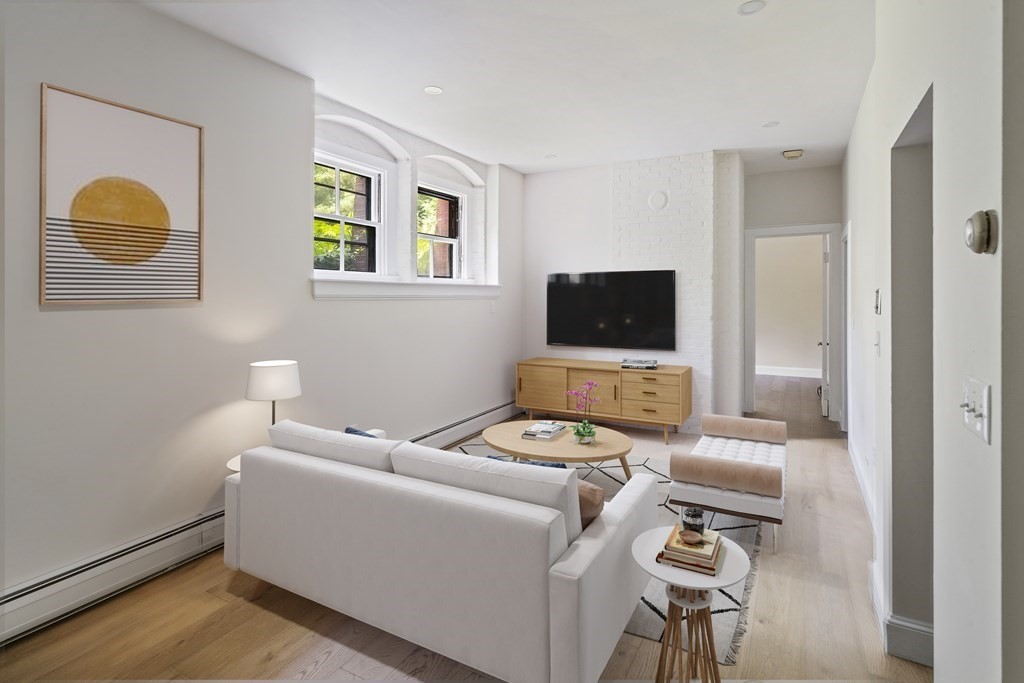 1000 Centre Street, Unit 3 Boston, MA 02130 - Photo 4 of 14 a living room with furniture and a flat screen tv