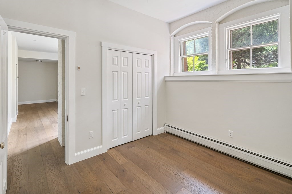 1000 Centre Street, Unit 3 Boston, MA 02130 - Photo 10 of 14 an empty room with windows and closet