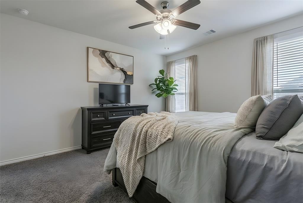 705 Jessica Lynn Lane Anna, TX 75409 - Photo 11 of 26 a bedroom with a bed and a chandelier