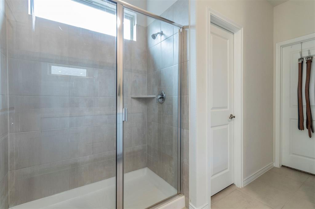 705 Jessica Lynn Lane Anna, TX 75409 - Photo 12 of 26 a bathroom with a glass shower door