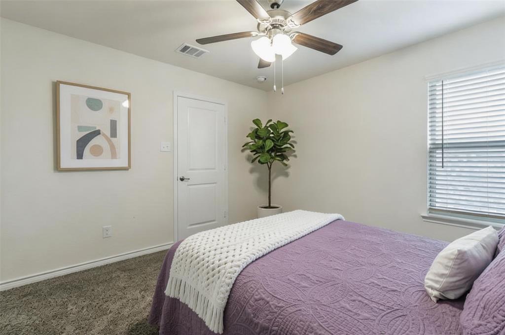 705 Jessica Lynn Lane Anna, TX 75409 - Photo 15 of 26 a bedroom with a bed and a chandelier