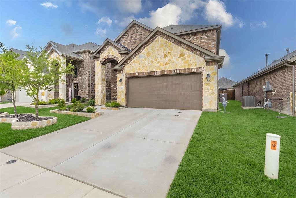 705 Jessica Lynn Lane Anna, TX 75409 - Photo 2 of 26 a front view of a house with a yard and garage