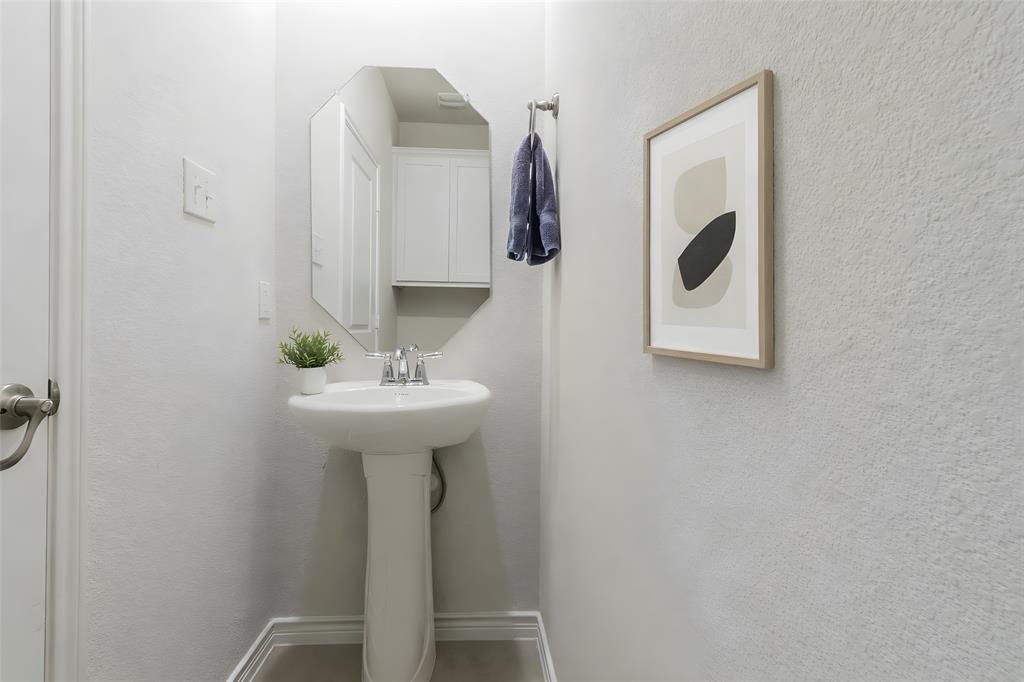 705 Jessica Lynn Lane Anna, TX 75409 - Photo 22 of 26 a bathroom with a sink and mirror
