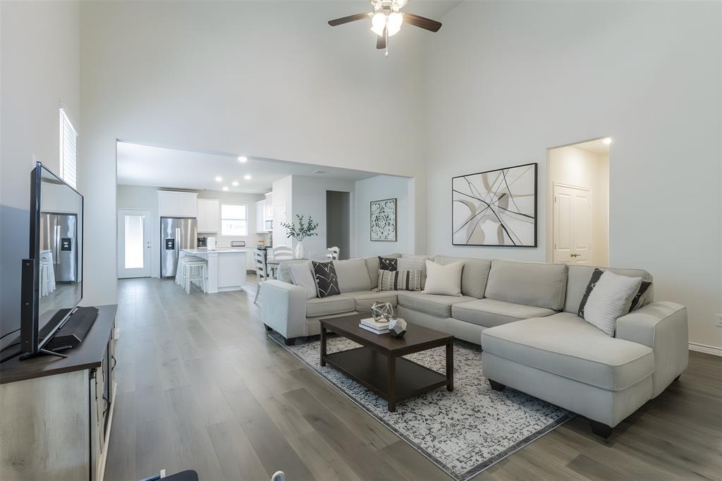 705 Jessica Lynn Lane Anna, TX 75409 - Photo 4 of 26 a living room with furniture wooden floor and a flat screen tv