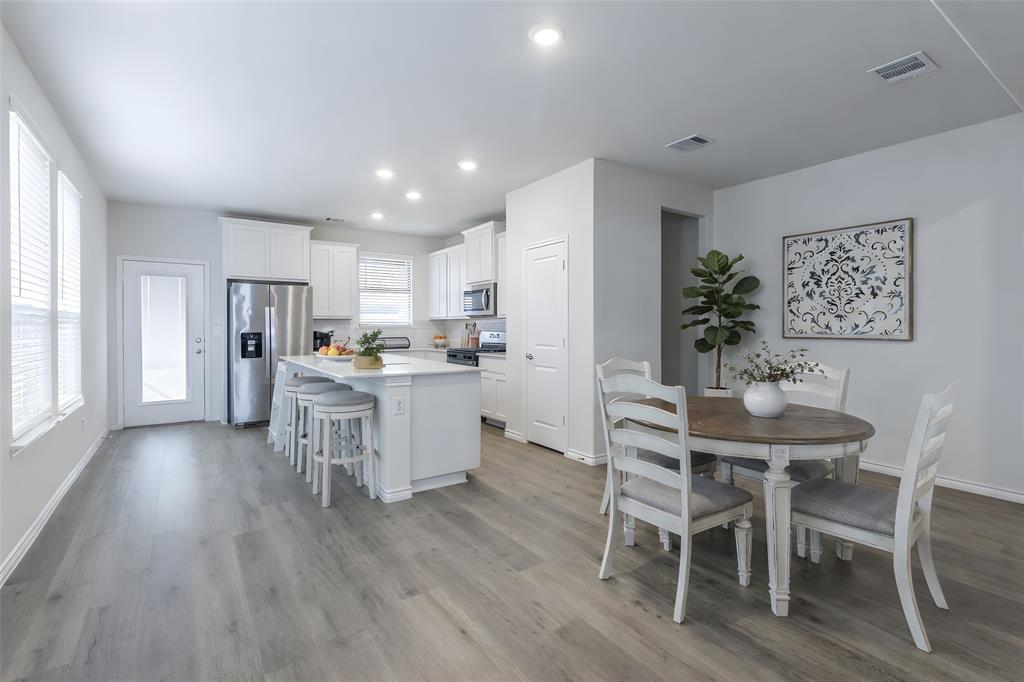 705 Jessica Lynn Lane Anna, TX 75409 - Photo 9 of 26 a kitchen with white cabinets and stainless steel appliances