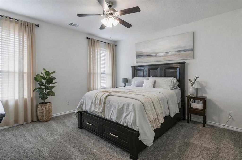 705 Jessica Lynn Lane Anna, TX 75409 - Photo 10 of 26 a spacious bedroom with a bed and a potted plant