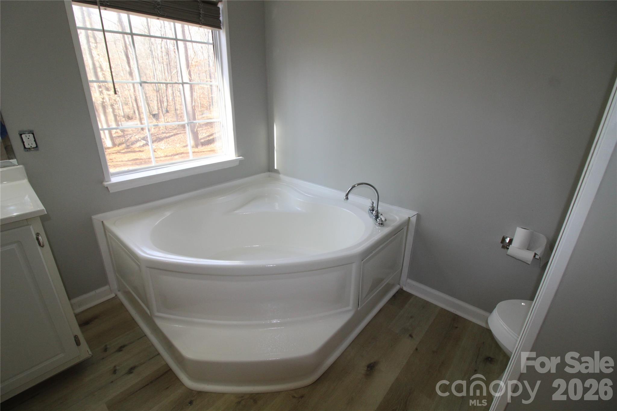 410 Johnstone Road Cleveland, NC 27013 - Photo 19 of 43 a white bath tub sitting in a bathroom next to a window