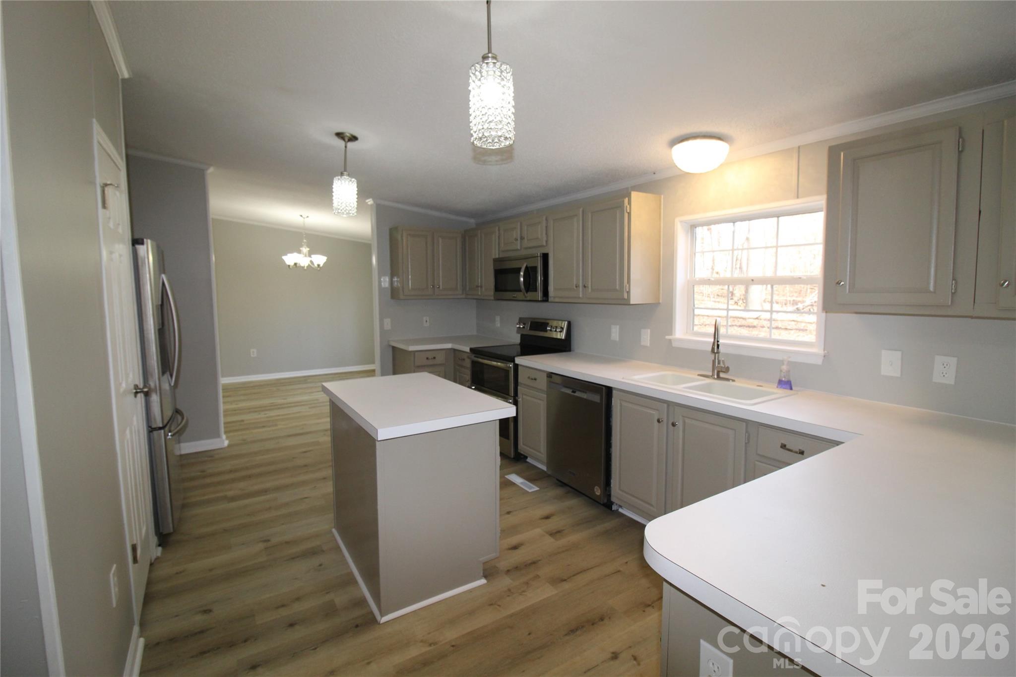 410 Johnstone Road Cleveland, NC 27013 - Photo 2 of 43 a kitchen with cabinets a sink stainless steel appliances and window