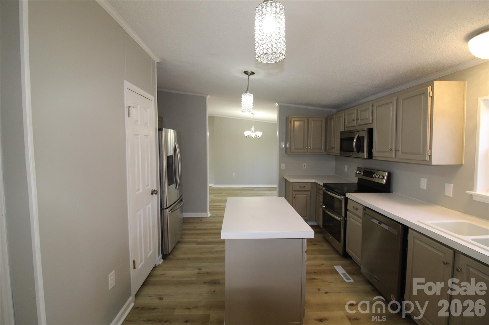 410 Johnstone Road Cleveland, NC 27013 - Photo 22 of 43 a kitchen with refrigerator and cabinets
