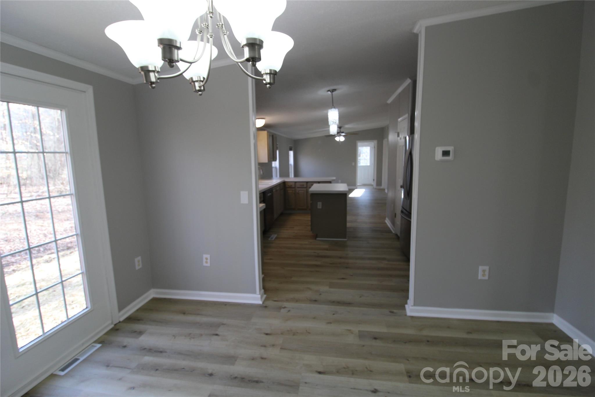 410 Johnstone Road Cleveland, NC 27013 - Photo 23 of 43 a view of a hallway with wooden floor and chandelier