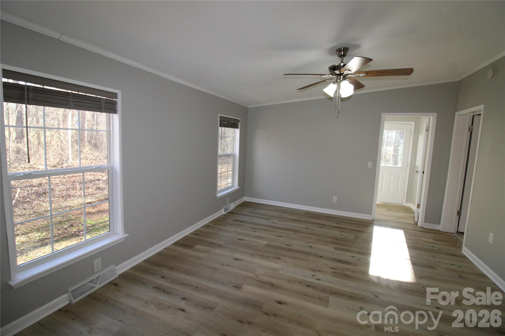 410 Johnstone Road Cleveland, NC 27013 - Photo 4 of 43 a view of an empty room with wooden floor and a window