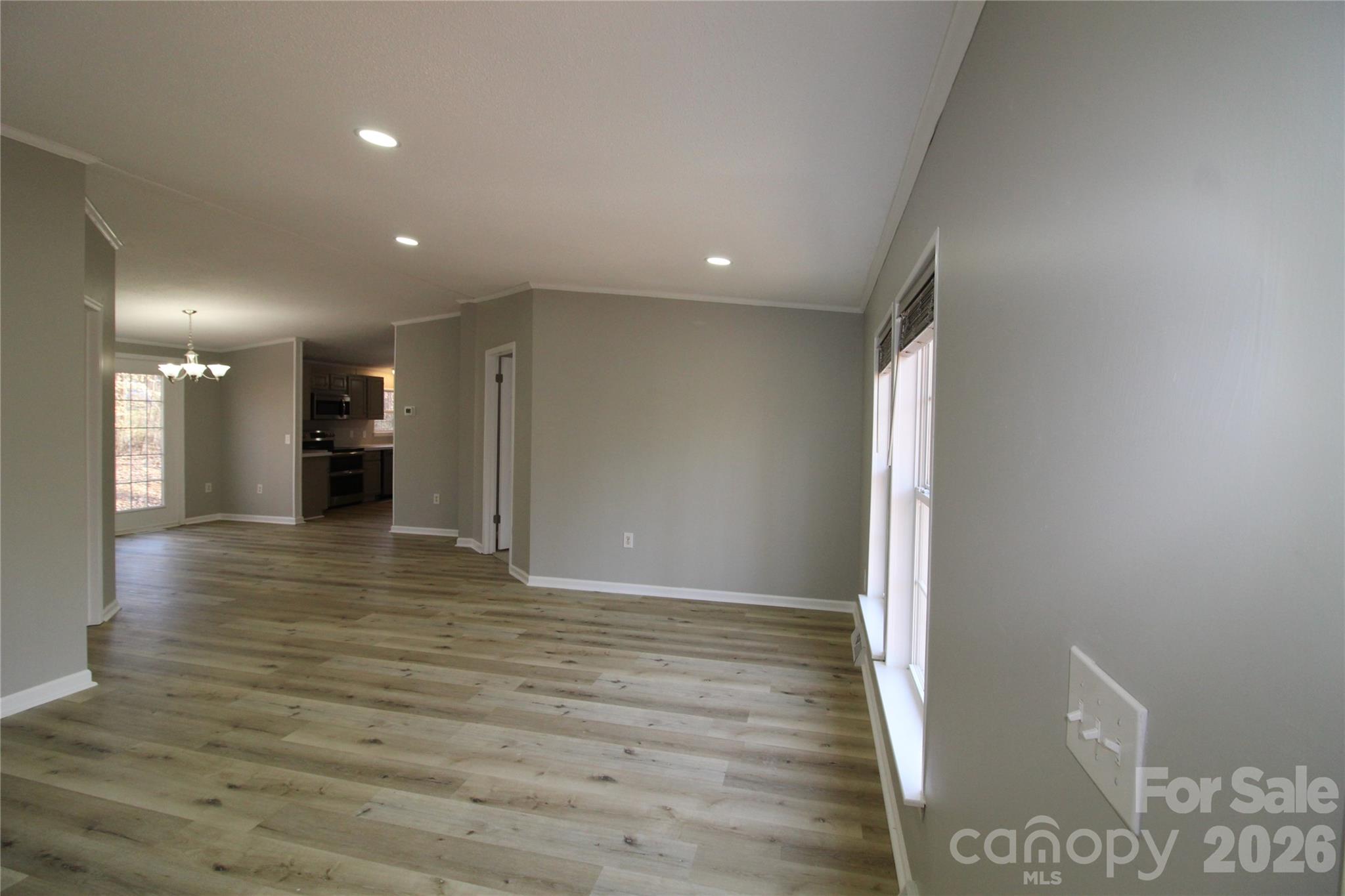 410 Johnstone Road Cleveland, NC 27013 - Photo 6 of 43 a view of a big room with wooden floor and windows