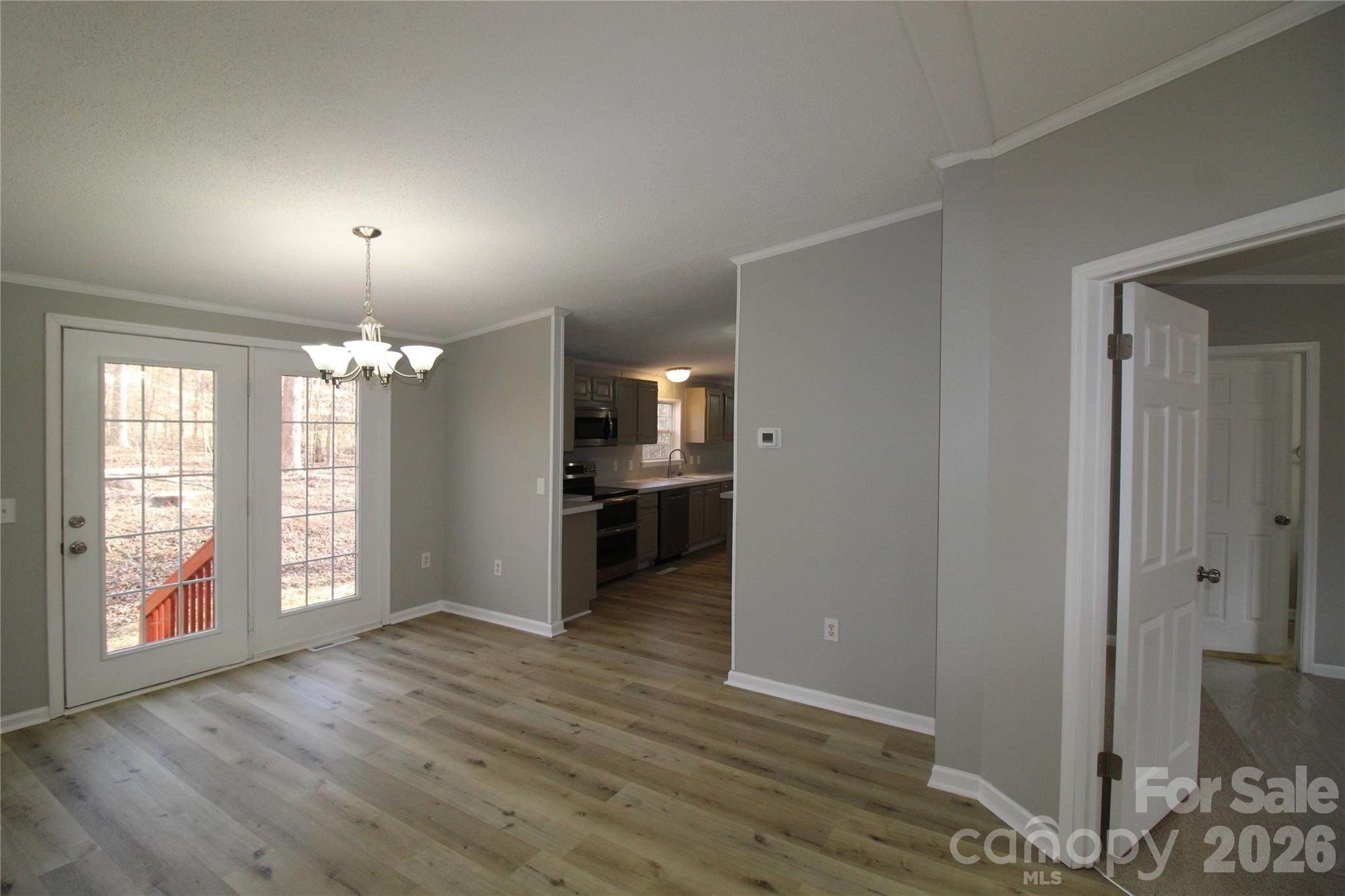 410 Johnstone Road Cleveland, NC 27013 - Photo 7 of 43 an empty room with wooden floor and windows