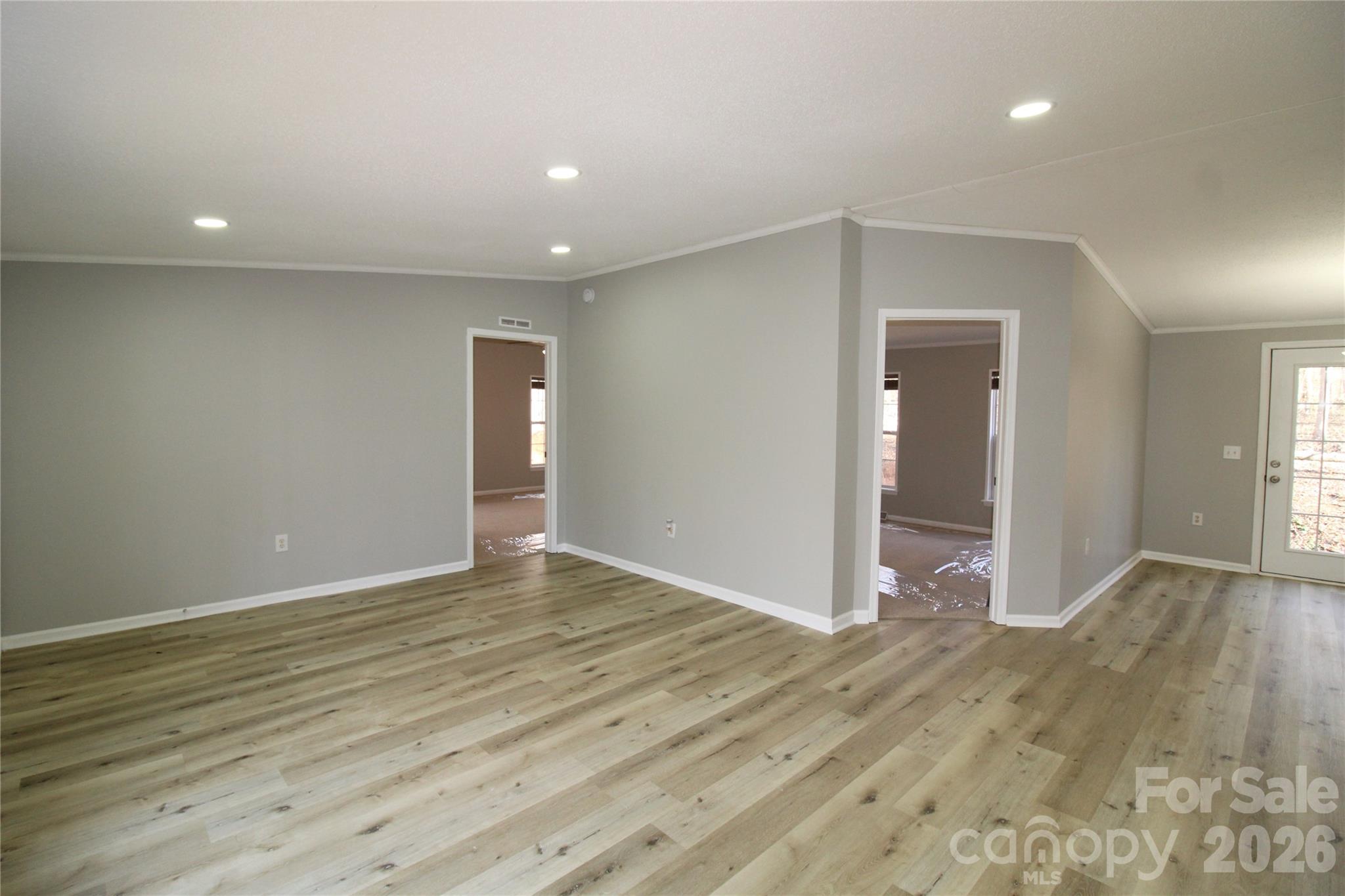 410 Johnstone Road Cleveland, NC 27013 - Photo 8 of 43 an empty room with wooden floor and natural light