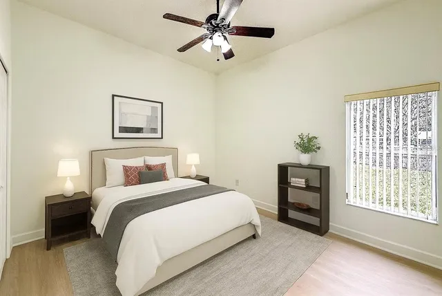 a bedroom with a bed and a chandelier