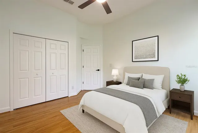 a bedroom with a bed and a chandelier