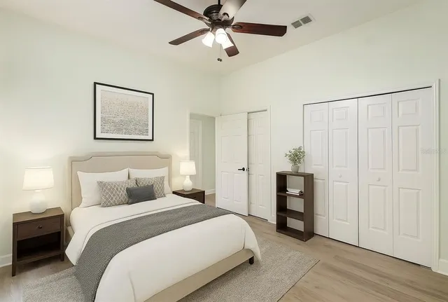 a bedroom with a bed and a chandelier