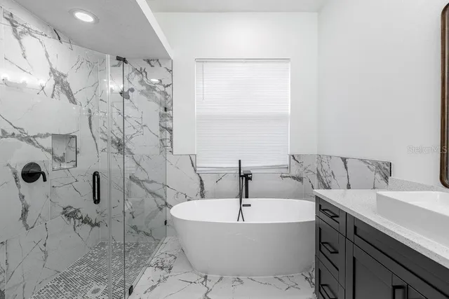 a bathroom with a bathtub and shower
