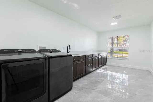 a kitchen with stainless steel appliances kitchen island granite countertop a stove a sink and a microwave