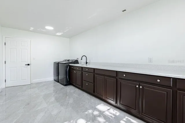 a kitchen with granite countertop a sink and cabinets