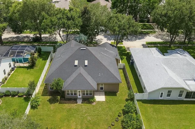 an aerial view of a house with a yard