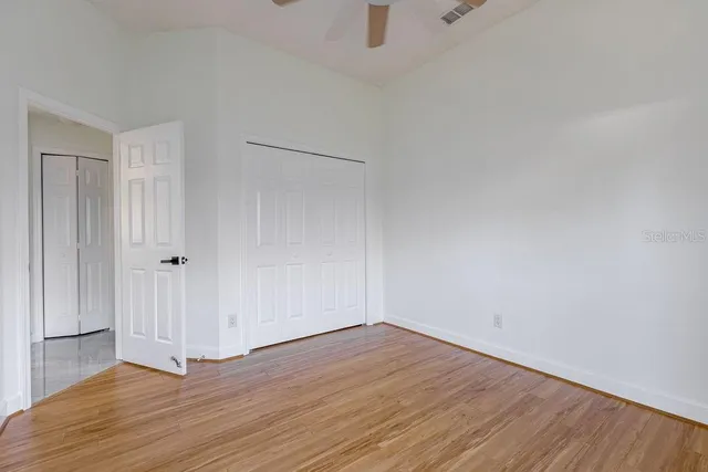 a view of an empty room with wooden floor