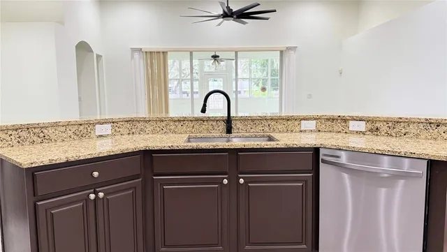 a view of a kitchen with a sink and cabinets