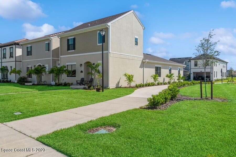 8072 Rungsted Lane Melbourne, FL 32940 - Photo 2 of 59 a front view of a house with a yard
