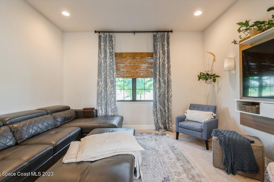 8072 Rungsted Lane Melbourne, FL 32940 - Photo 22 of 59 a bedroom with furniture and a large window