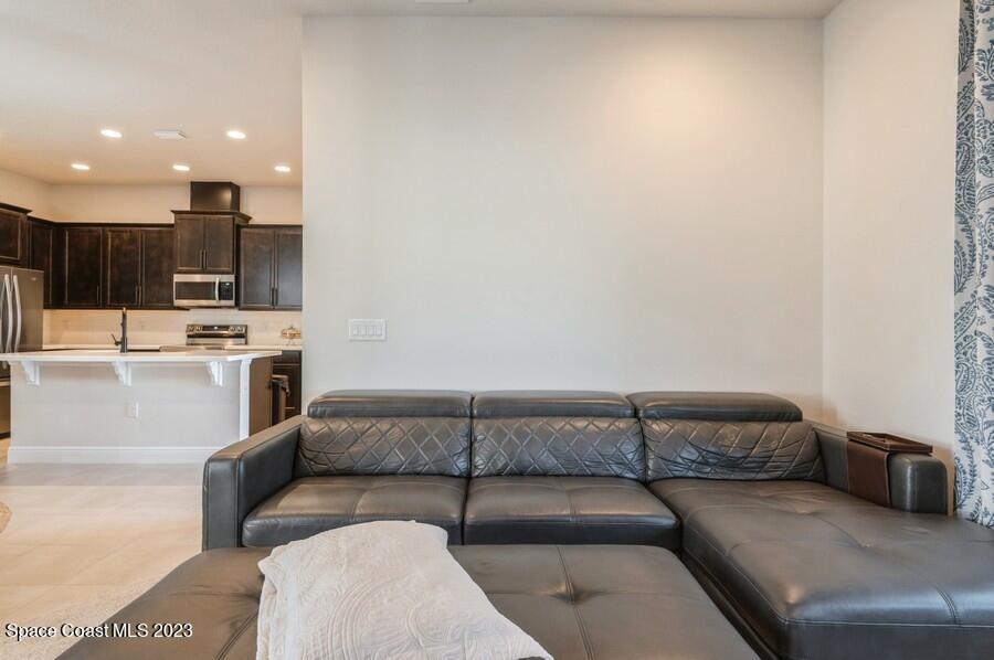8072 Rungsted Lane Melbourne, FL 32940 - Photo 23 of 59 a living room with furniture and a couch