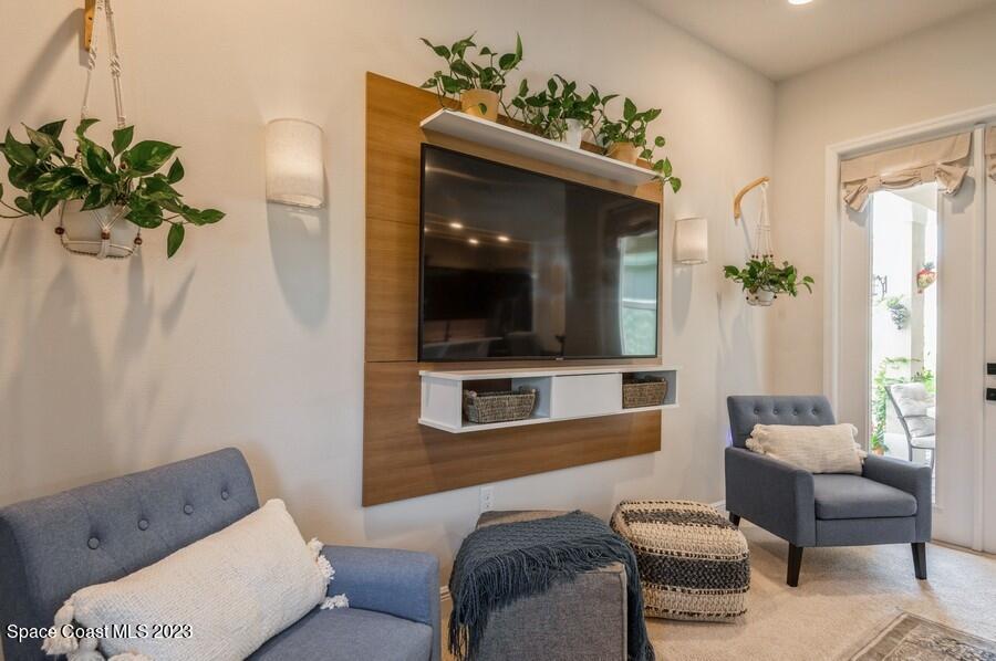 8072 Rungsted Lane Melbourne, FL 32940 - Photo 25 of 59 a living room with furniture and a potted plant