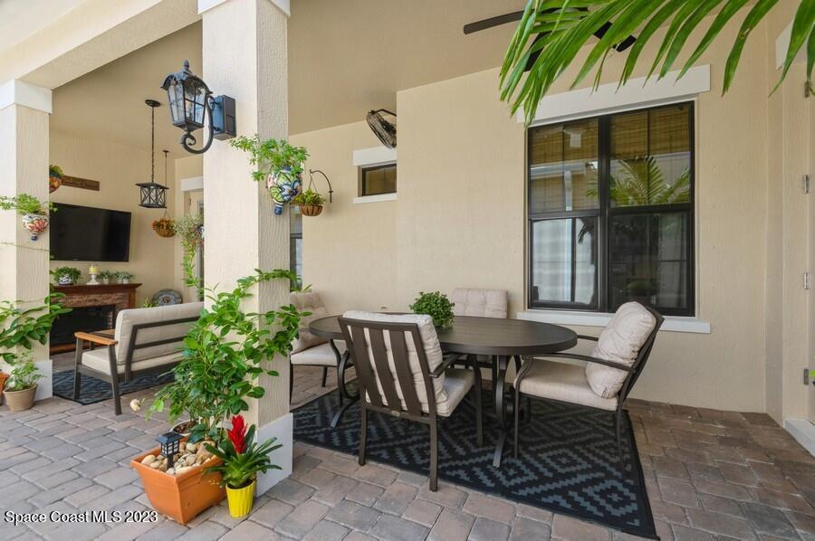 8072 Rungsted Lane Melbourne, FL 32940 - Photo 27 of 59 a view of a dining room with furniture and a potted plant