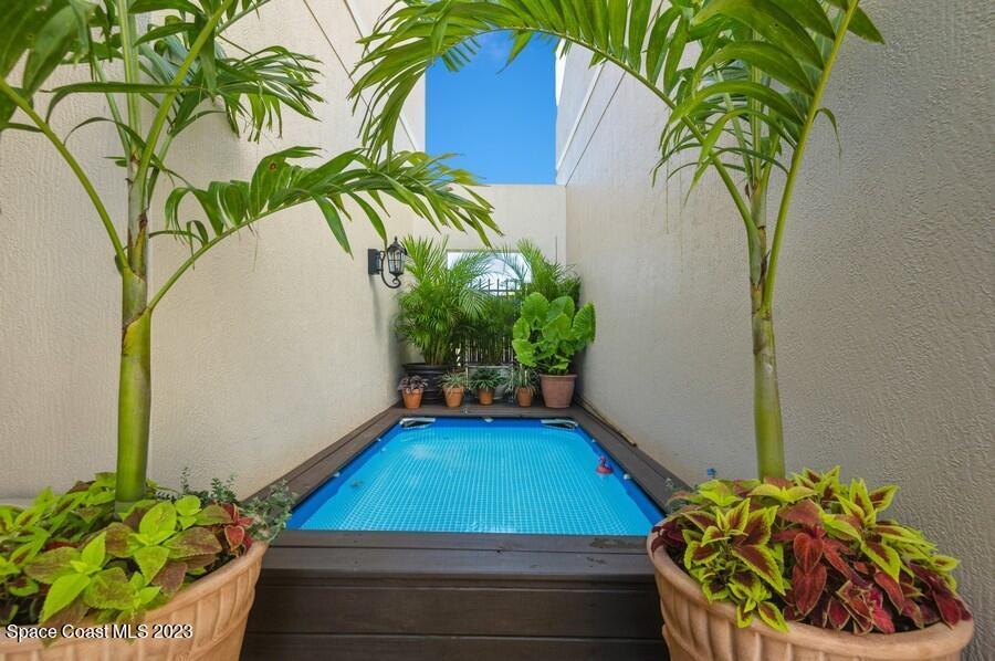 8072 Rungsted Lane Melbourne, FL 32940 - Photo 28 of 59 a view of a backyard with plants and a potted plant