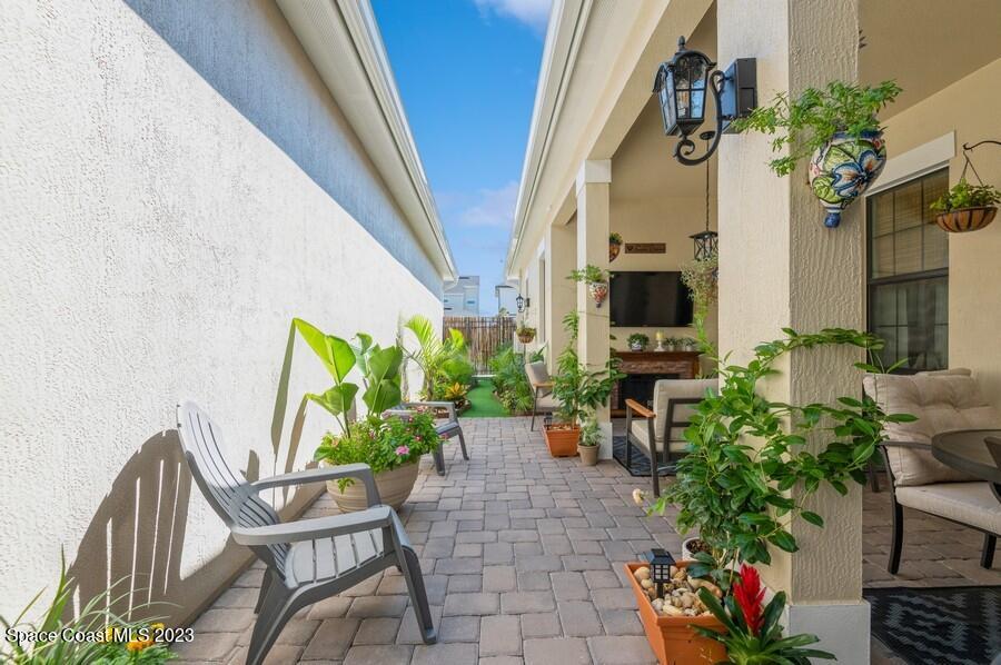 8072 Rungsted Lane Melbourne, FL 32940 - Photo 29 of 59 a view of a porch with chairs and potted plants