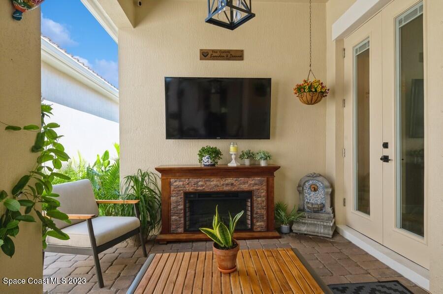 8072 Rungsted Lane Melbourne, FL 32940 - Photo 30 of 59 a living room with furniture and a fireplace