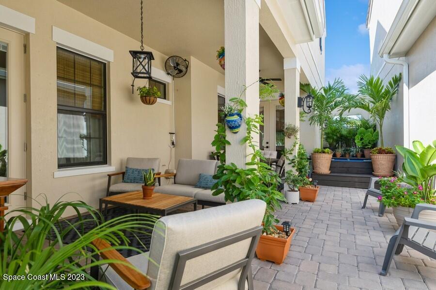 8072 Rungsted Lane Melbourne, FL 32940 - Photo 32 of 59 a view of a patio with plants and chairs