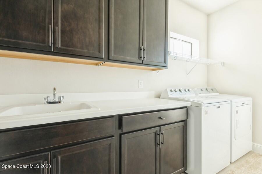 8072 Rungsted Lane Melbourne, FL 32940 - Photo 35 of 59 a bathroom with a sink and a mirror