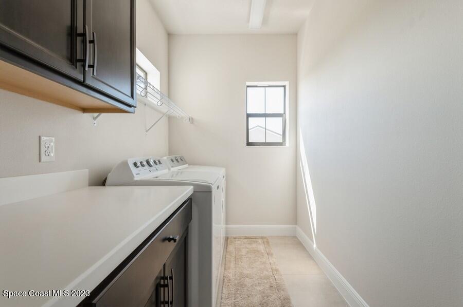 8072 Rungsted Lane Melbourne, FL 32940 - Photo 38 of 59 a bathroom with a sink a vanity and a window