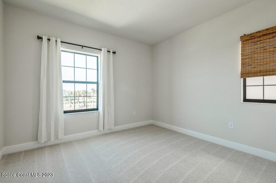 8072 Rungsted Lane Melbourne, FL 32940 - Photo 41 of 59 an empty room with windows